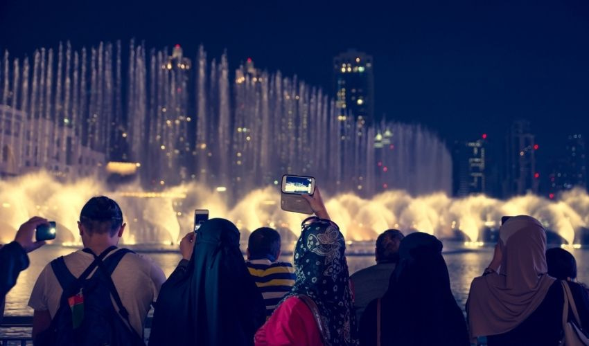 Tourist taking a photo of the Bellagio Fountains