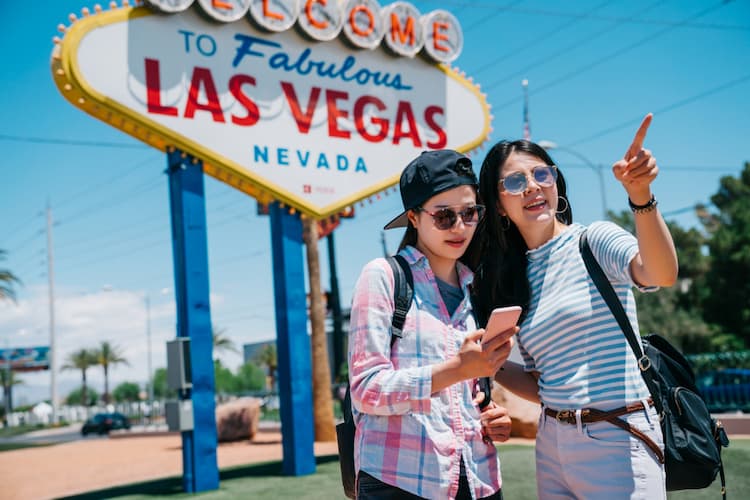Tourists posing near Las Vegas sign