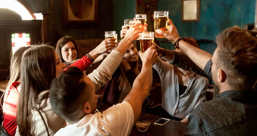 People toasting beer at a brewery