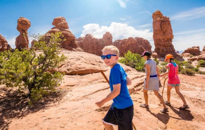 A family hiking along a desert trail