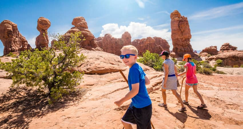 A family hiking along a desert trail