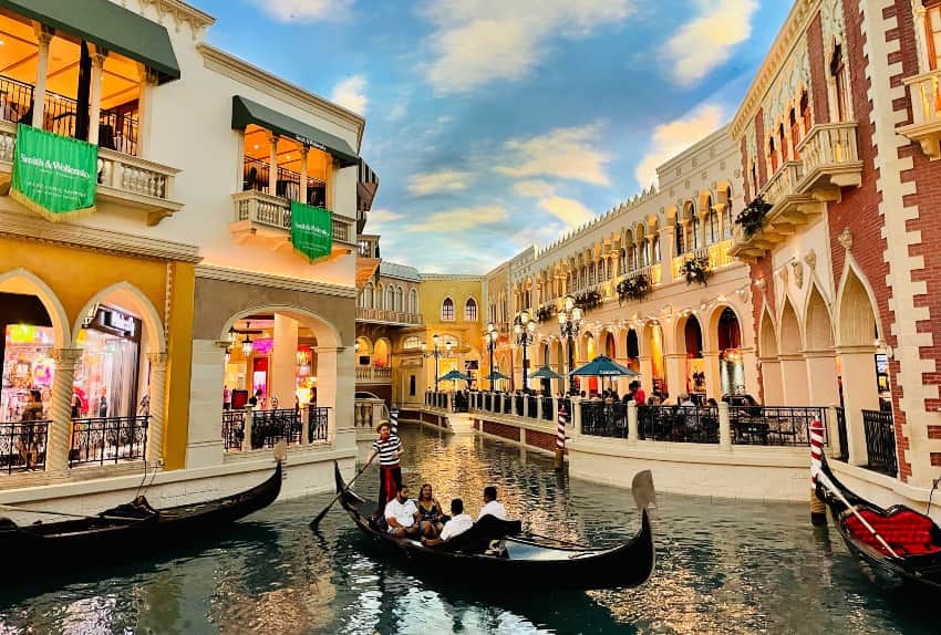 people taking a gondola ride at the venetian las vegas