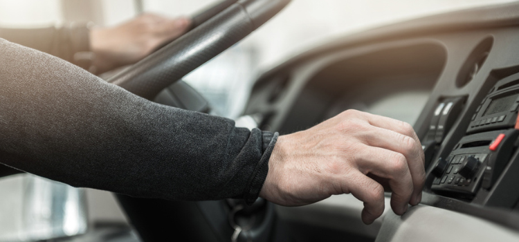 photo of a charter bus steering wheel with somebody's arm