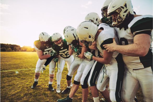 football players huddle before a game