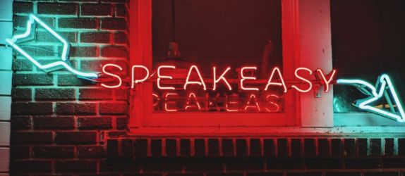 a neon speakeasy sign